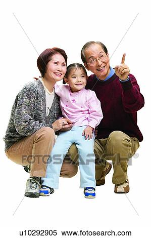 Stock Photography - Mature Couple, Sweater, Pointing, Smiling, Mature Men. Fotosearch