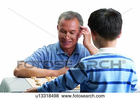 Sitting, Grandparent, Standing, Eyeglasses, Black Hair, Looking Down View Large Photo Image Stock Photo - Sitting, Grandparent, Standing, Eyeglasses, Black Hair, Looking Down. Fotosearch