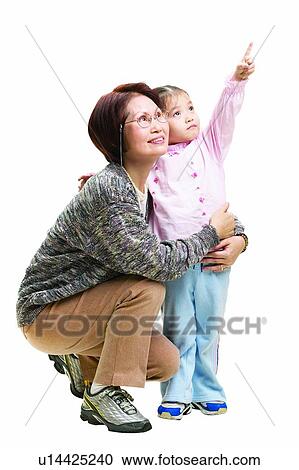 Stock Image - Sports Shoe, Hand Raised, Grandchild, Eyeglasses, Looking Up. Fotosearch