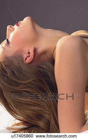Stock Image - One Young Woman Only, Flirty Couples I, Individuality, Human Face, Lying On Back, Head Back. Fotosearch