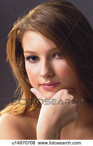 Stock Photo - Thinking, Solitude, Lady, Looking At Camera, Hand On Chin, Woman. Fotosearch