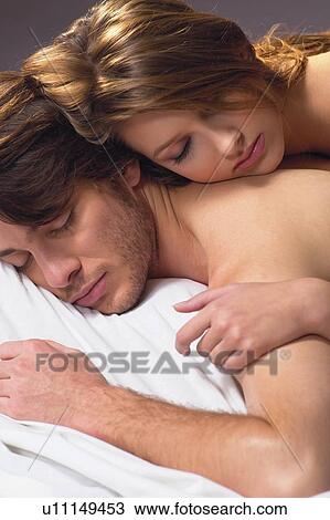 Stock Image - Two People, Young Women, Relaxation, Semi-Dress, Eyes Closed, Young Couple. Fotosearch