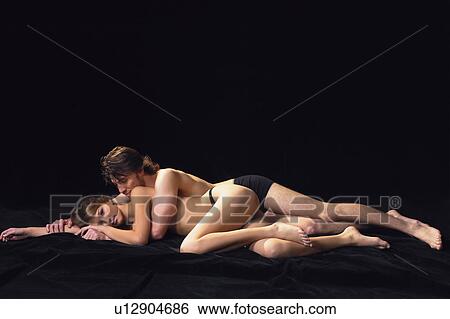 Stock Photograph - Black Background, Brown Hair, Adults Only. Fotosearch