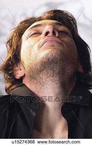 Stock Photo - Close-Up, Young Adult, Content, Contemplation, Head Back. Fotosearch
