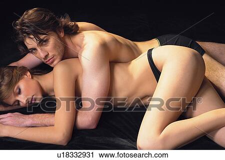 Stock Image - Flirty Couples II, Heterosexual Couple, Young Men, Relaxation, Portrait, Sexual Activity. Fotosearch