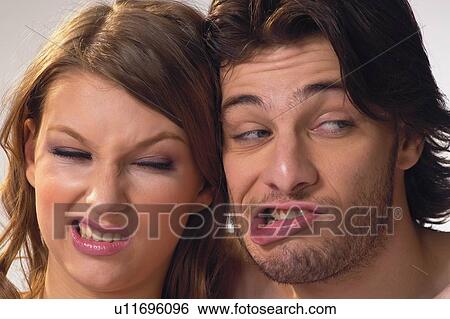 Stock Photograph - Togetherness, Looking Away, White Background, Side By Side, Making A Face. Fotosearch