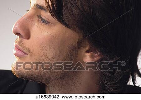 Stock Image - White Background, Male, Young Adult, Casual Clothing, Indoor, Looking Sideways. Fotosearch