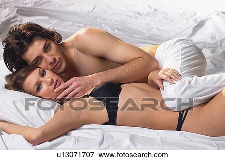 Stock Photo - Lying On Back, Togetherness, Loving, Flirty Couples III, Sensuality, Love, Portrait. Fotosearch
