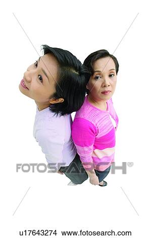 White Background, Two Generation Family, Posing, Sweater, Back To Back, Portrait, Indoor View Large Photo Image Picture - White Background, Two Generation Family, Posing, Sweater, Back To Back, Portrait, Indoor. Fotosearch