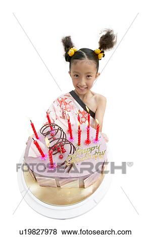 Stock Photo - Casual Clothing, Asian Ethnicity, Candle, Cake, Black Hair, Cheerful, 10-11 Years. Fotosearch