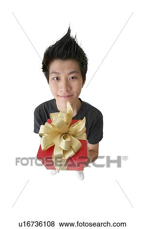 Stock Photo - Legs Apart, Spiky Hair, One Teenage Boy Only, Asian Ethnicity, Looking At Camera. Fotosearch
