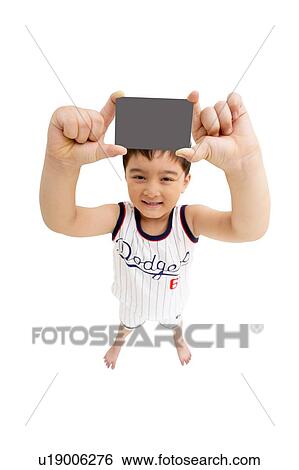 Stock Photograph - Shorts, One Boy Only, Posing, 8-9 Years, Legs Apart, Human Hand. Fotosearch