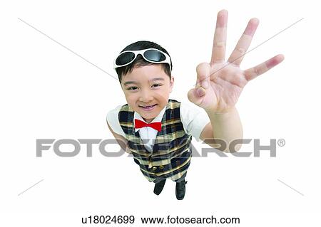 Stock Photo - Gesturing, Child, Bow Tie, Signals, Looking At Camera, Hand On Hip, Focus Signals. Fotosearch