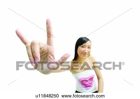 Stock Image - Hand Sign, Joy, Casual Clothing, Indoor, White Background, Looking At Camera. Fotosearch