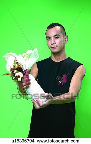 Picture - Gift, Colored Background, Gift Signals, One Young Man Only, Looking At Camera. Fotosearch