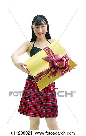 Stock Image - Indoor, White Background, Toothy Smile, Gift Signals, One Young Woman Only. Fotosearch