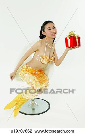 Stock Image - Young Adult, Surprise, Celebration, Posing, One Object, Gift. Fotosearch