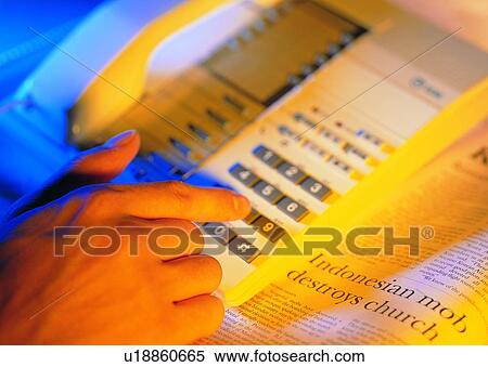 Stock Photography - dialing, telephone, hand, newspaper, calling. Fotosearch