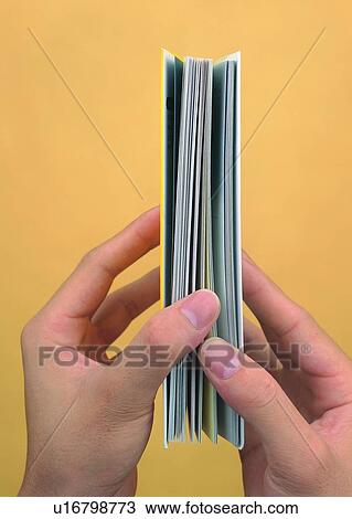 Stock Image - hands, book, opening, thumb, thumbnail, finger. Fotosearch