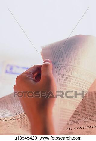 Stock Image - newspaper, finger, thumb, hand, reading. Fotosearch