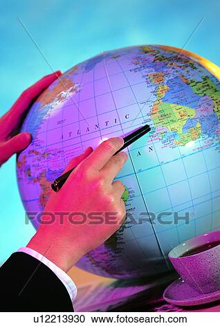 Stock Image - globe, indoor, light, hand, shadow, action. Fotosearch