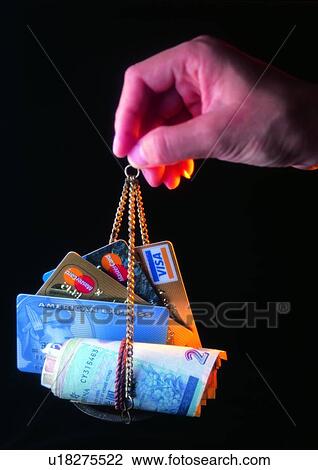Stock Image - indoor, action, credit card, hand, money, object, shadow. Fotosearch