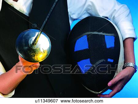 Stock Photo - indoor, sword, hand, object, helmet, shadow, action. Fotosearch
