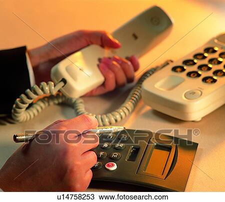 Stock Image - light, indoor, shadow, hand, calculater, action, telephone. Fotosearch