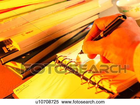 Stock Photography - light, writing, action, notebook, pen, shadow. Fotosearch