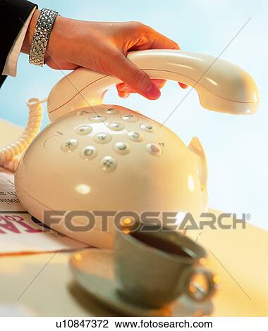 Stock Image - woringk, shadow, telephone, action, cup, hand, business. Fotosearch