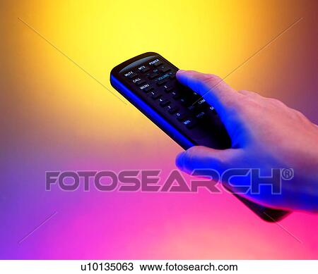 Stock Image - electric appliance, hand, remote control. Fotosearch