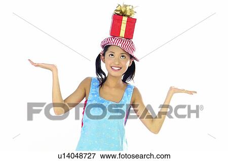 Stock Photo - Arm Outstretched, Body Language, Baseball Cap, Asian Ethnicity, Apron. Fotosearch