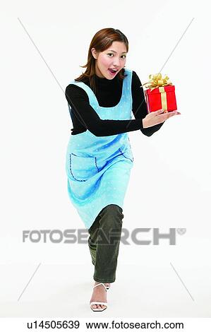 Stock Photo - Asian Ethnicity, Brown Hair, Body Language, Bending, Apron. Fotosearch