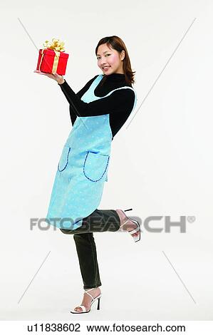 Stock Image - Asian Ethnicity, Casual Clothing, Brown Hair, Body Language, Apron. Fotosearch