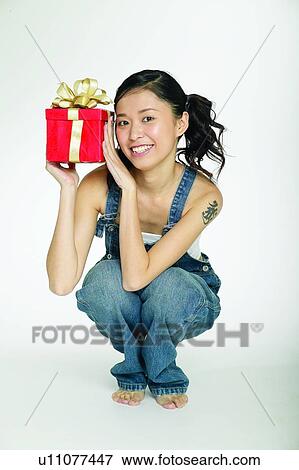 Stock Photo - Barefoot, Body Language, Young Adult, Indoor, Overalls. Fotosearch