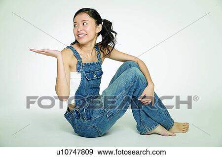 Stock Photo - Barefoot, Casual Clothing, Brown Hair, Body Language, Asian Ethnicity. Fotosearch