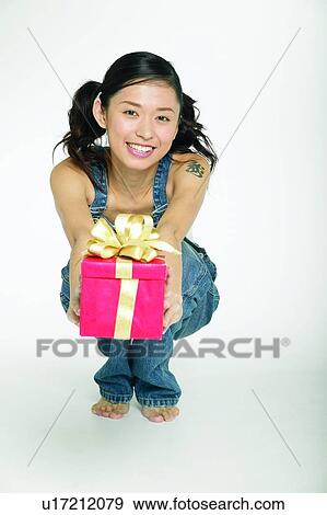 Stock Photo - Barefoot, Casual Clothing, Brown Hair, Body Language, Asian Ethnicity. Fotosearch