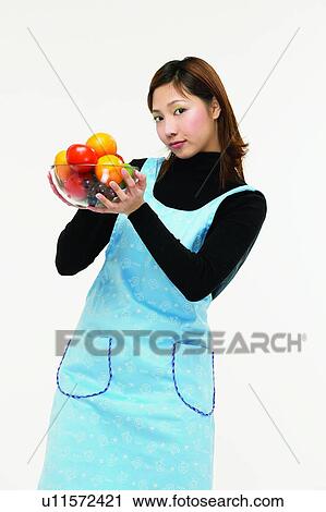 Stock Image - Casual Clothing, Apron, Brown Hair, Body Language, Asian Ethnicity, Apple. Fotosearch