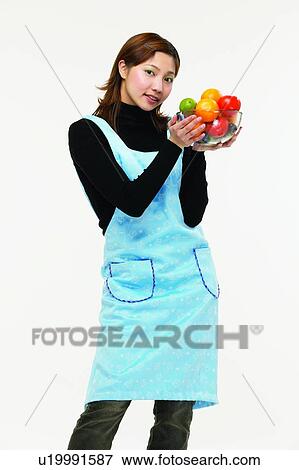 Stock Photo - Casual Clothing, Apron, Brown Hair, Body Language, Asian Ethnicity, Apple. Fotosearch