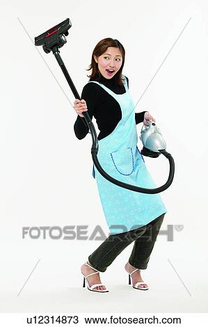 Stock Image - Casual Clothing, Asian Ethnicity, Brown Hair, Body Language, Bending, Apron. Fotosearch