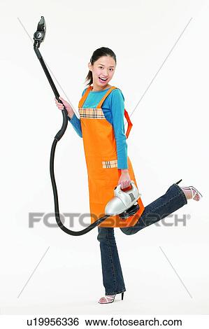 Stock Photograph - Cleaning, Asian Ethnicity, Casual Clothing, Brown Hair, Body Language, Apron. Fotosearch