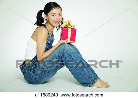 Holding, Pigtails, Body Language, Casual Clothing, Gift View Large Photo Image Stock Image - Holding, Pigtails, Body Language, Casual Clothing, Gift. Fotosearch