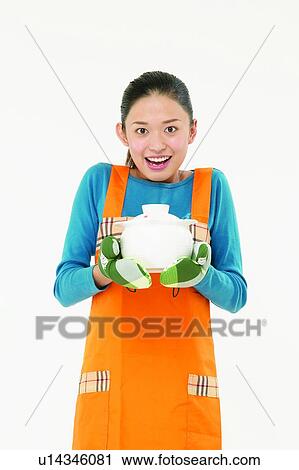 Stock Image - Housewife Body Language, Looking At Camera, Apron, Asian Ethnicity. Fotosearch