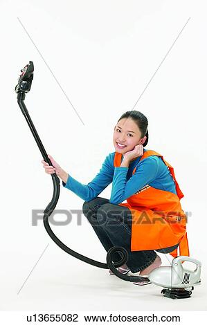 Stock Image - Lifestyles, Posing, Cleaning, Crouching. Fotosearch