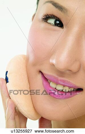 Stock Photo - Asian Ethnicity, Close-Up, Applying. Fotosearch
