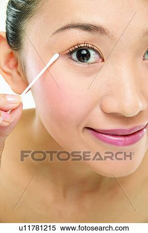 Stock Photography - Asian Ethnicity, Close-Up, Applying. Fotosearch
