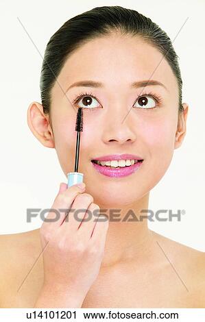 Stock Image - Asian Ethnicity, Close-Up, Black Hair, Applying. Fotosearch
