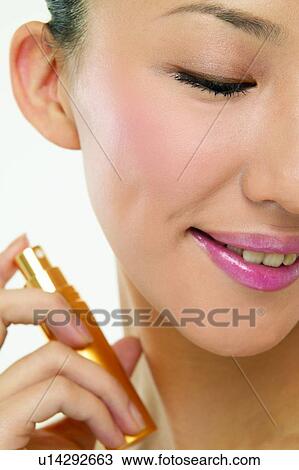 Stock Image - One Young Woman Only, Care, Body Care, Eyes Closed, Holding, Human Finger. Fotosearch