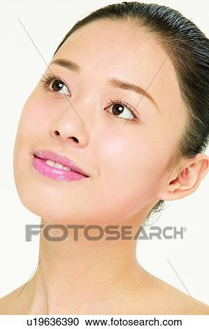 Stock Image - Young Adult, Thinking, Inner Beauty, Indoor, Smirking. Fotosearch