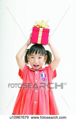 Stock Photo - Carrying On Head, Asian Ethnicity, Body Language, Black Hair, Bangs, Casual Clothing, 4-5 Years. Fotosearch
